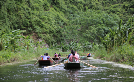 Students are travelling down a river via boat in Vietnam